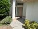 Front entrance with tan door and white columns at 9108 Bassett Ln # B, New Port Richey, FL 34655