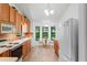 Kitchen with oak cabinets, tile backsplash, and a breakfast nook at 9108 Bassett Ln # B, New Port Richey, FL 34655