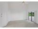 Spacious bedroom featuring a ceiling fan and sliding doors to a patio at 9108 Bassett Ln # B, New Port Richey, FL 34655