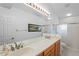 Double vanity bathroom with a shower and plenty of light at 9108 Bassett Ln # B, New Port Richey, FL 34655