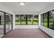 Sunroom with wall-to-wall windows and view of backyard at 9108 Bassett Ln # B, New Port Richey, FL 34655