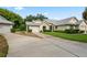 Tan two-car garage villa with gray roof and landscaping at 9108 Bassett Ln # B, New Port Richey, FL 34655