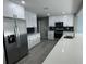 Modern kitchen with white cabinets, stainless steel appliances, and quartz countertops at 470 S Florida Ave, Tarpon Springs, FL 34689