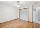 Well-lit bedroom with wood-look floors and access to a bathroom at 1096 Florian Way, Spring Hill, FL 34609