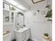 Clean bathroom with a single vanity, decorative shelving and plants at 1096 Florian Way, Spring Hill, FL 34609