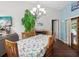 Charming dining room with floral tablecloth and hardwood floors at 1096 Florian Way, Spring Hill, FL 34609