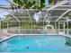 Inviting swimming pool with a screened enclosure at 1096 Florian Way, Spring Hill, FL 34609