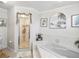 Bright bathroom with a walk-in shower and corner bathtub at 1096 Florian Way, Spring Hill, FL 34609