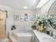 Relaxing bathroom featuring a corner soaking tub, double vanity, and decorative accents at 1096 Florian Way, Spring Hill, FL 34609