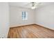 Spacious bedroom featuring wood-look floors and a ceiling fan at 1096 Florian Way, Spring Hill, FL 34609
