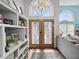 Elegant entryway with stained glass doors and built-in shelving at 1096 Florian Way, Spring Hill, FL 34609