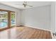 Bright bedroom with wood flooring and French doors leading to the pool at 1096 Florian Way, Spring Hill, FL 34609
