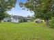 Large backyard with home view, hot tub, and mature trees at 1096 Florian Way, Spring Hill, FL 34609