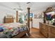 Large main bedroom with a post bed, ceiling fan and hardwood floors at 1096 Florian Way, Spring Hill, FL 34609