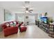 Living room with a red leather sectional sofa and a mounted TV at 1096 Florian Way, Spring Hill, FL 34609