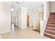 Open living room with tile floors and access to kitchen and stairs at 5614 Red Snapper Ct, New Port Richey, FL 34652