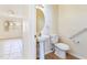 Clean bathroom with pedestal sink, toilet, and grab bar at 5614 Red Snapper Ct, New Port Richey, FL 34652