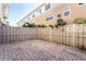 Private backyard with brick pavers and wood fence at 5614 Red Snapper Ct, New Port Richey, FL 34652