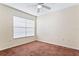 Well-lit bedroom with brown carpet and ceiling fan at 5614 Red Snapper Ct, New Port Richey, FL 34652