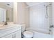 Clean bathroom with tub, toilet and white vanity at 5614 Red Snapper Ct, New Port Richey, FL 34652