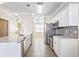 Modern kitchen with white cabinets, stainless steel appliances, and quartz countertops at 5614 Red Snapper Ct, New Port Richey, FL 34652