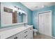 Updated bathroom with a white vanity and light blue walls at 9178 Lake Chase Island Way, Tampa, FL 33626