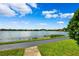 Scenic lakefront view with walking path and lush green space at 9178 Lake Chase Island Way, Tampa, FL 33626