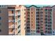 Exterior view of a light peach colored condominium building with balconies and waterfront access at 4516 Seagull Dr # 414, New Port Richey, FL 34652