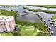 Aerial view of waterfront property with a condo, boat docks, and lush greenery at 4516 Seagull Dr # 414, New Port Richey, FL 34652