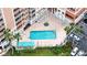 Complex pool and spa with surrounding patio and parking at 4516 Seagull Dr # 414, New Port Richey, FL 34652