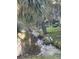 Backyard view with natural pond, wildlife, and abundant vegetation create a serene and natural setting at 12307 Fieldstone Ln, Hudson, FL 34667