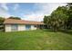 Expansive backyard with lush greenery and mature trees, offering a private outdoor space and room to relax at 12307 Fieldstone Ln, Hudson, FL 34667