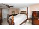 Bedroom featuring a four-poster bed, dark wood furniture, and soft lighting at 12307 Fieldstone Ln, Hudson, FL 34667