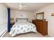 Bright bedroom with a ceiling fan, seashell themed bedding, and a large dresser at 12307 Fieldstone Ln, Hudson, FL 34667