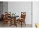 Cozy dining area featuring a glass-top table, elegant chairs, and a brick wall, great for relaxation at 12307 Fieldstone Ln, Hudson, FL 34667