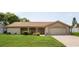 Charming single-story home featuring a stone facade, well-maintained lawn, and an attached two-car garage at 12307 Fieldstone Ln, Hudson, FL 34667