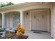 Inviting front entrance featuring a double door, decorative plants, and covered porch at 12307 Fieldstone Ln, Hudson, FL 34667