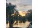 Beautiful sunset reflecting on the calm lake waters, creating a serene backdrop to this waterfront property at 12307 Fieldstone Ln, Hudson, FL 34667