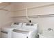 Functional laundry room with modern washer and dryer, providing convenience and storage at 12307 Fieldstone Ln, Hudson, FL 34667