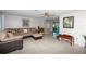 Spacious living room with sectional sofa, tile flooring, and ample seating at 12307 Fieldstone Ln, Hudson, FL 34667