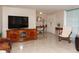 Open-concept living room with entertainment center and views to the front door at 12307 Fieldstone Ln, Hudson, FL 34667