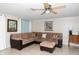 Comfortable living room area with sectional sofa and tile floors at 12307 Fieldstone Ln, Hudson, FL 34667