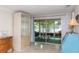 Bright sunroom featuring glass display cabinet and a waterfront dining area at 12307 Fieldstone Ln, Hudson, FL 34667
