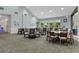 Bright dining room with multiple tables and chairs, suitable for residents and guests at 11724 Heritage Point Dr, Hudson, FL 34667