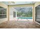 Inviting screened-in pool area with brick pavers at 34838 Arbor Green Pl, Zephyrhills, FL 33541