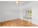 Bedroom with hardwood floors and view of living room at 5060 Secretariat Run, Spring Hill, FL 34609