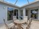 Spacious covered patio with table and chairs, perfect for entertaining at 18937 Grand Club Dr, Hudson, FL 34667