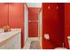 Bathroom with red walls, a shower, and a double vanity at 21360 Race Horse Ln, Brooksville, FL 34604