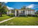 Two-story condo building with balconies and lush landscaping at 2522 Pine Ridge S Way # A2, Palm Harbor, FL 34684