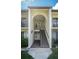 Condo building entry with stairs and outdoor lighting at 2522 Pine Ridge S Way # A2, Palm Harbor, FL 34684